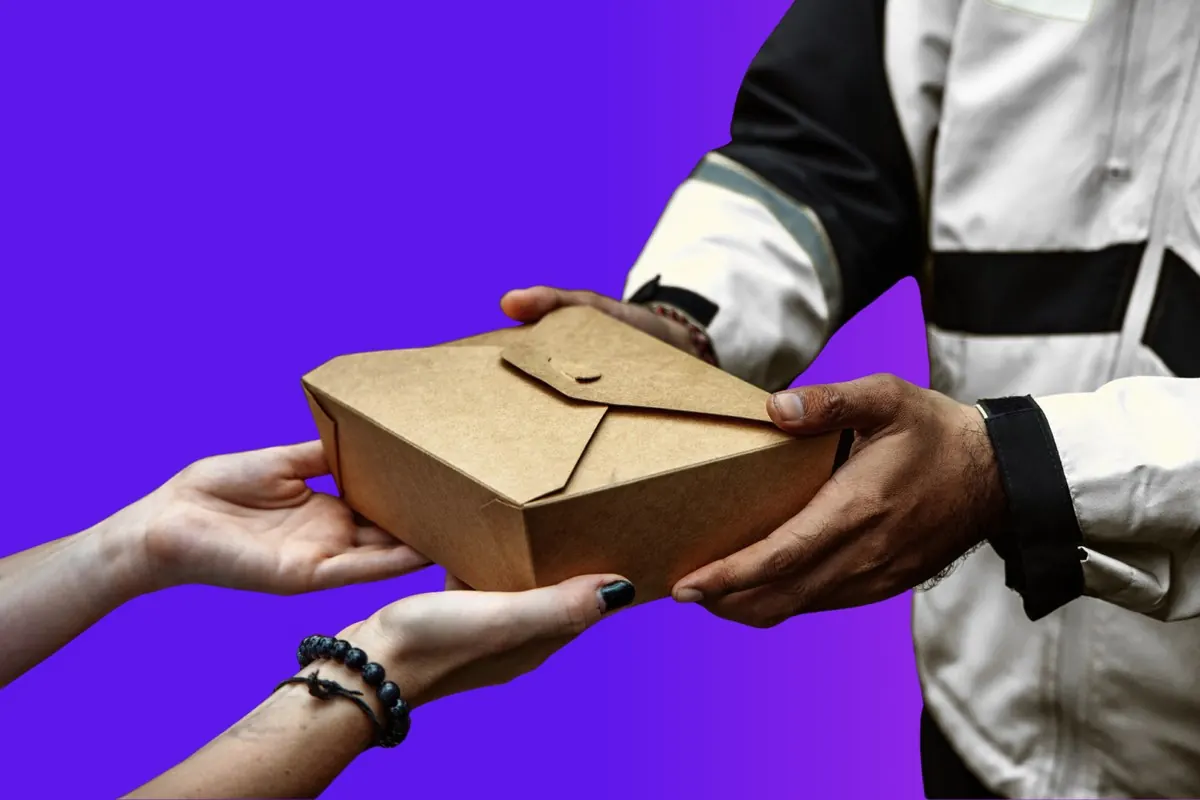 LocalDesi rider handing food parcel to customer in Brisbane